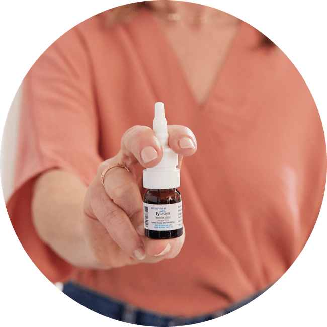 Image of person holding a 4.2 mL bottle of Tyrvaya® (varenicline solution) nasal spray