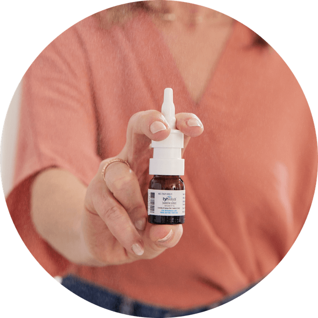 Image of person holding a 4.2 mL bottle of Tyrvaya® (varenicline solution) nasal spray