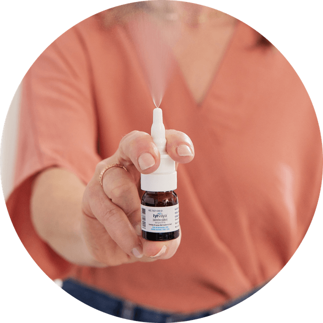 Image of person holding a 4.2 mL bottle of Tyrvaya® (varenicline solution) nasal spray